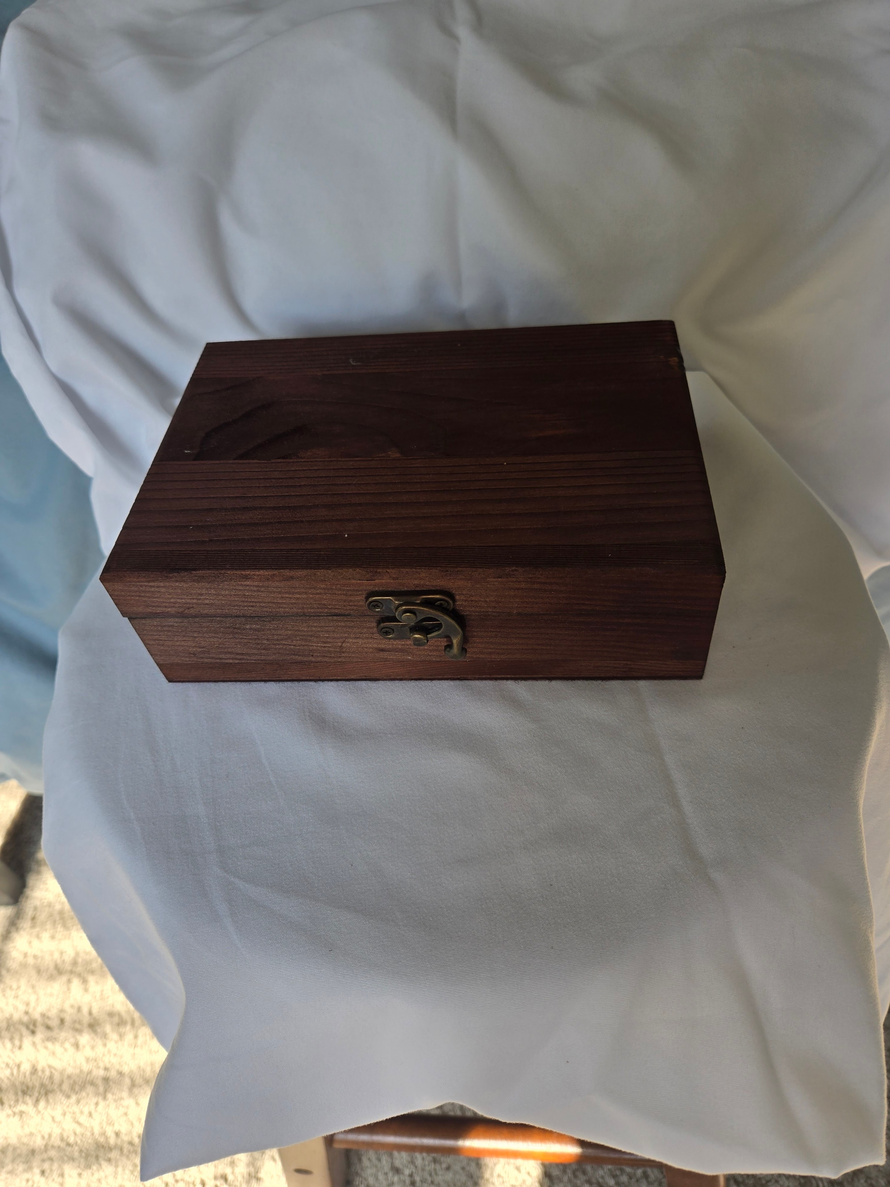 Just Because box — closed, showing warm wood finish